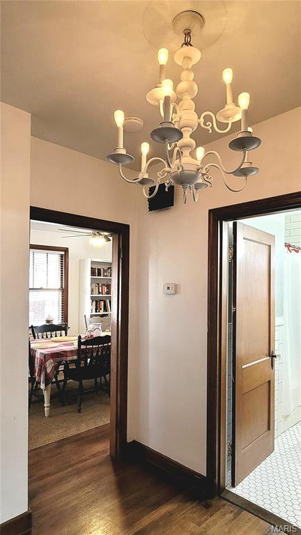 305 Williams St, Washington, MO 63090 - hall with dark wood-style floors and a chandelier
