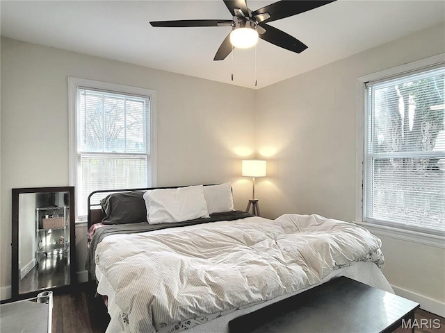 305 Williams St, Washington, MO 63090 - bedroom with wood finished floors, multiple windows, and a ceiling fan