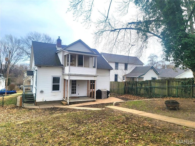 305 Williams St, Washington, MO 63090 - back of house with a fire pit, a chimney, a fenced backyard, and a patio