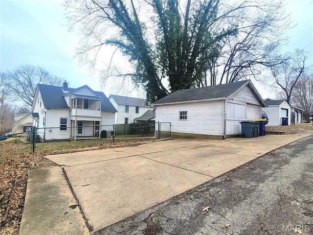 305 Williams St, Washington, MO 63090 - back of house featuring an outbuilding, a chimney, and a residential view