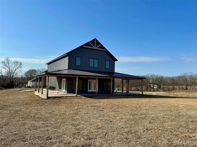 4727 Walnut Creek Dr, Palmyra, MO 63461 - back of property featuring metal roof and board and batten siding