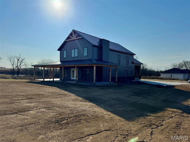4727 Walnut Creek Dr, Palmyra, MO 63461 - view of front of property featuring covered porch, metal roof, and board and batten siding