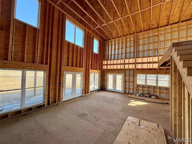 4727 Walnut Creek Dr, Palmyra, MO 63461 - unfurnished living room featuring a towering ceiling and french doors
