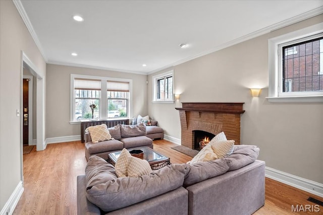 6230 Waterman Ave, Saint Louis, MO 63130 - living room with ornamental molding, a fireplace, baseboards, light wood-style flooring, and recessed lighting