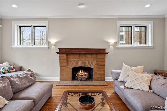 6230 Waterman Ave, Saint Louis, MO 63130 - living room with wood finished floors, baseboards, crown molding, recessed lighting, and a brick fireplace