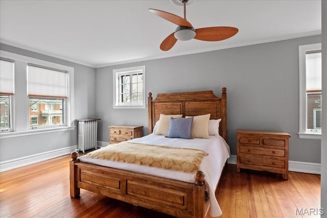 6230 Waterman Ave, Saint Louis, MO 63130 - bedroom with radiator, hardwood / wood-style flooring, crown molding, baseboards, and ceiling fan