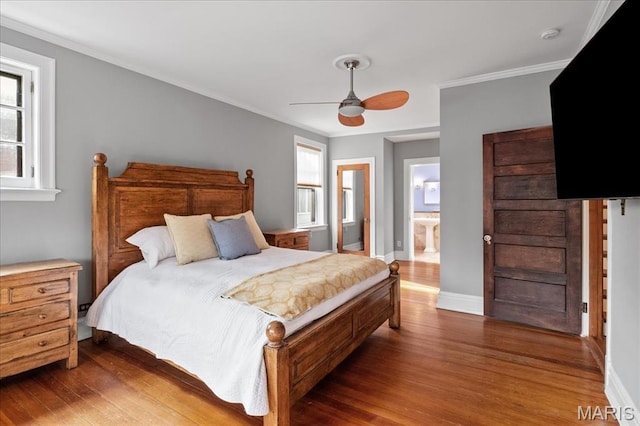 6230 Waterman Ave, Saint Louis, MO 63130 - bedroom with wood finished floors, multiple windows, ensuite bathroom, and crown molding