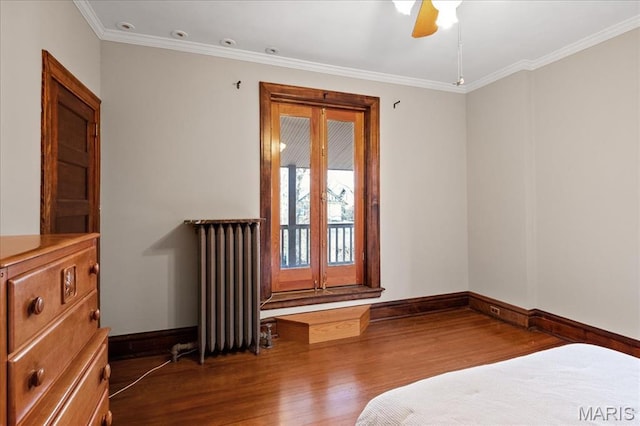 6230 Waterman Ave, Saint Louis, MO 63130 - unfurnished bedroom with radiator heating unit, wood finished floors, baseboards, crown molding, and access to outside