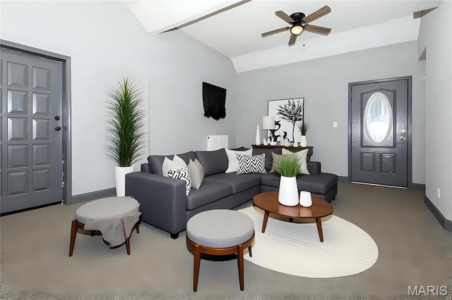 living area featuring vaulted ceiling, ceiling fan, and baseboards