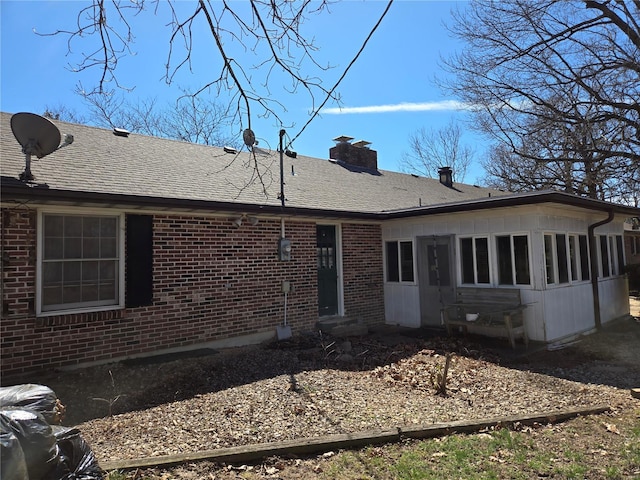400 Smith Rd, Lebanon, MO 65536 - back of property featuring brick siding, a chimney, a sunroom, and roof with shingles