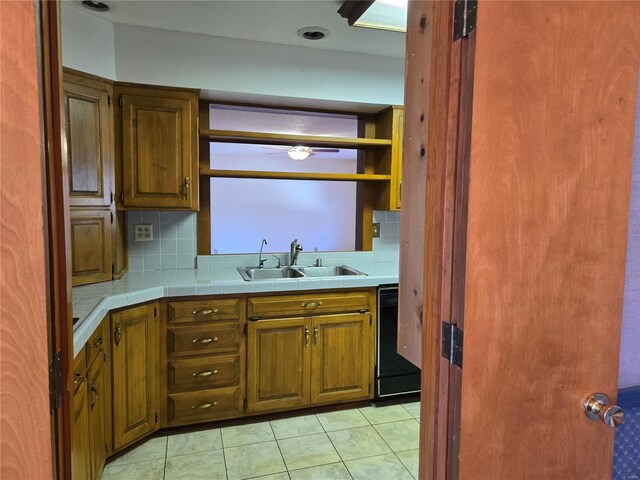 400 Smith Rd, Lebanon, MO 65536 - kitchen with a sink, dishwasher, backsplash, brown cabinets, and light tile patterned floors