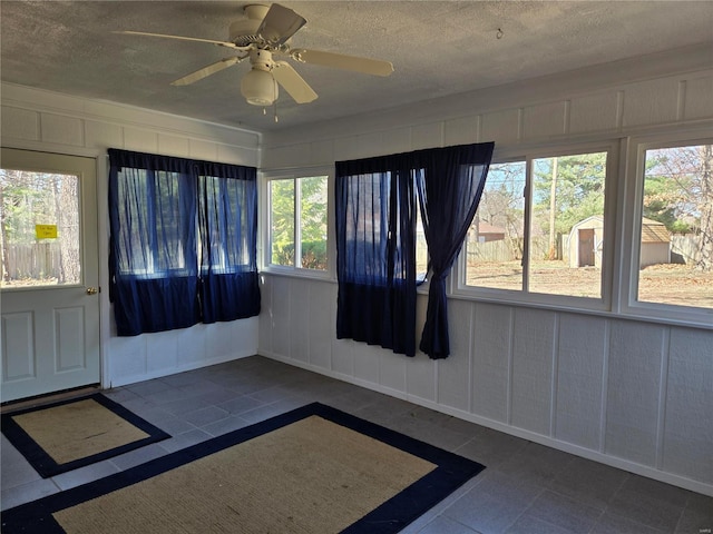 400 Smith Rd, Lebanon, MO 65536 - unfurnished sunroom featuring tile patterned floors, a textured ceiling, and a decorative wall