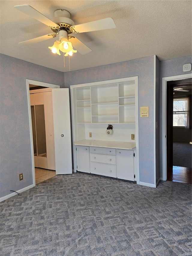 400 Smith Rd, Lebanon, MO 65536 - unfurnished bedroom with carpet, a textured ceiling, baseboards, and ceiling fan