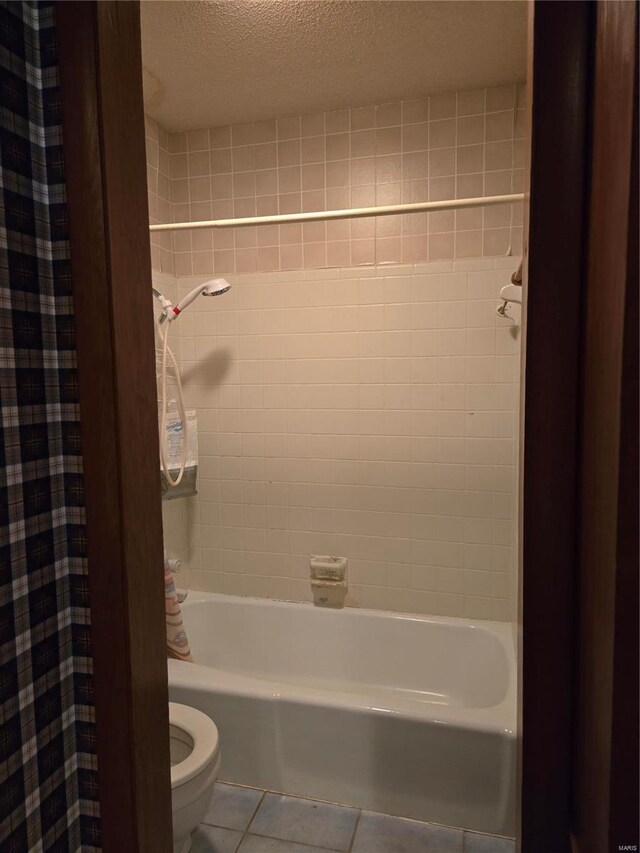 400 Smith Rd, Lebanon, MO 65536 - bathroom with tile patterned flooring, toilet, a textured ceiling, and shower / bath combo with shower curtain