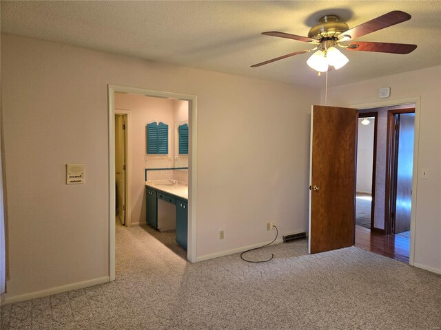 400 Smith Rd, Lebanon, MO 65536 - unfurnished bedroom featuring light colored carpet, baseboards, a textured ceiling, and connected bathroom