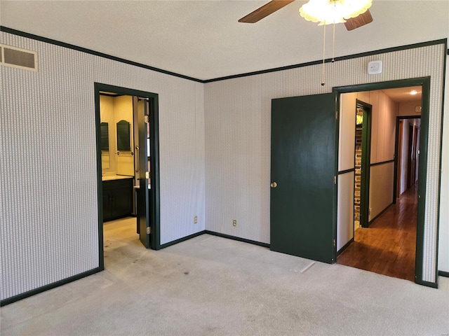 400 Smith Rd, Lebanon, MO 65536 - unfurnished bedroom featuring crown molding, carpet floors, a textured ceiling, baseboards, and ensuite bath