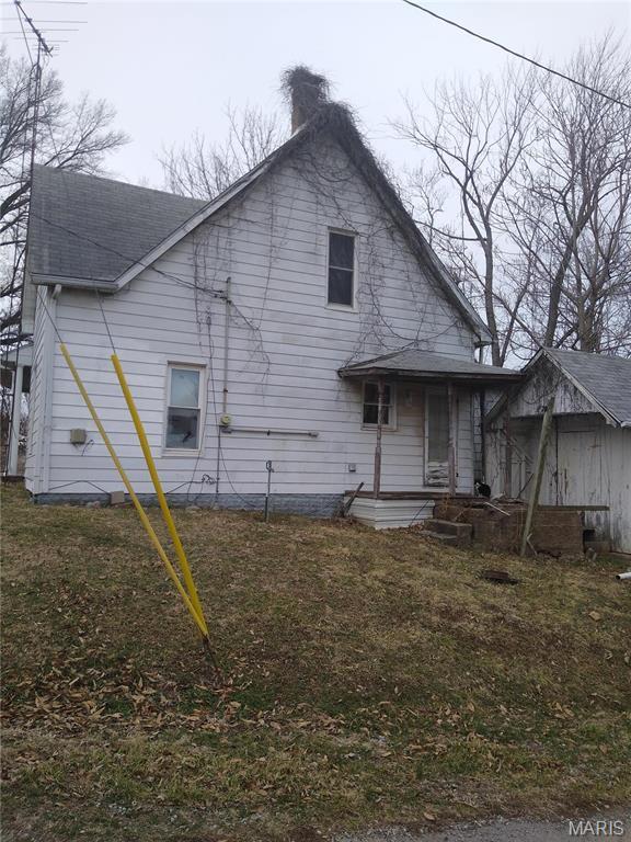 607 E Hancock St, Steeleville, IL 62288 - rear view of property with a chimney, a shingled roof, and a yard