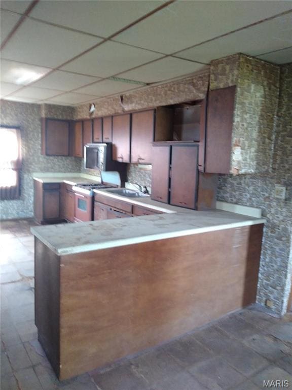 607 E Hancock St, Steeleville, IL 62288 - kitchen featuring a drop ceiling, gas range, light countertops, open shelves, and a sink