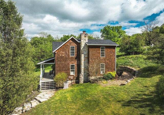19530 County Road 3620, St James, MO 65559 - view of side of home featuring a chimney, a yard, a shingled roof, and a deck