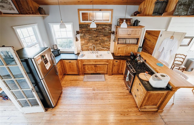 19530 County Road 3620, St James, MO 65559 - kitchen featuring a sink, light wood finished floors, appliances with stainless steel finishes, and pendant lighting