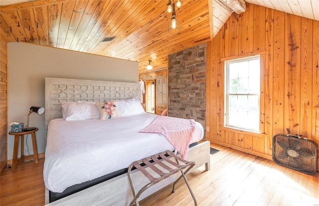 19530 County Road 3620, St James, MO 65559 - bedroom with vaulted ceiling, wood walls, wood ceiling, and light wood-type flooring