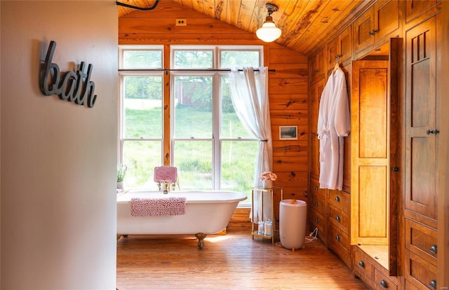 19530 County Road 3620, St James, MO 65559 - bathroom with lofted ceiling, wood finished floors, wooden walls, wood ceiling, and a freestanding tub