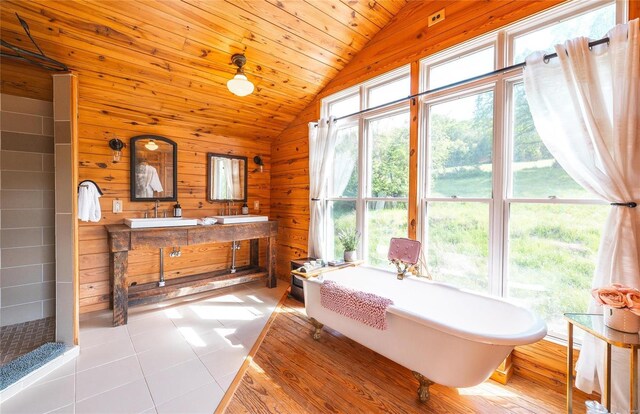 19530 County Road 3620, St James, MO 65559 - full bath featuring lofted ceiling, a freestanding bath, vanity, wooden walls, and tile patterned floors