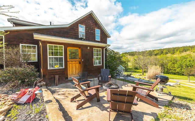 19530 County Road 3620, St James, MO 65559 - rear view of property with a fire pit
