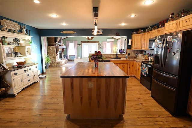 1988 Ripley Route Cc, Doniphan, MO 63935 - kitchen with black appliances, butcher block countertops, recessed lighting, light wood-style flooring, and a kitchen island