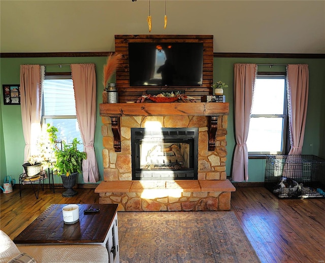 1988 Ripley Route Cc, Doniphan, MO 63935 - living area with hardwood / wood-style flooring, a stone fireplace, plenty of natural light, and ornamental molding