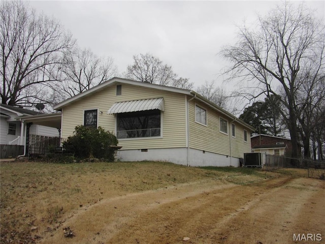 1415 Woodland Rd, Poplar Bluff, MO 63901 - view of property exterior with crawl space, fence, and central AC