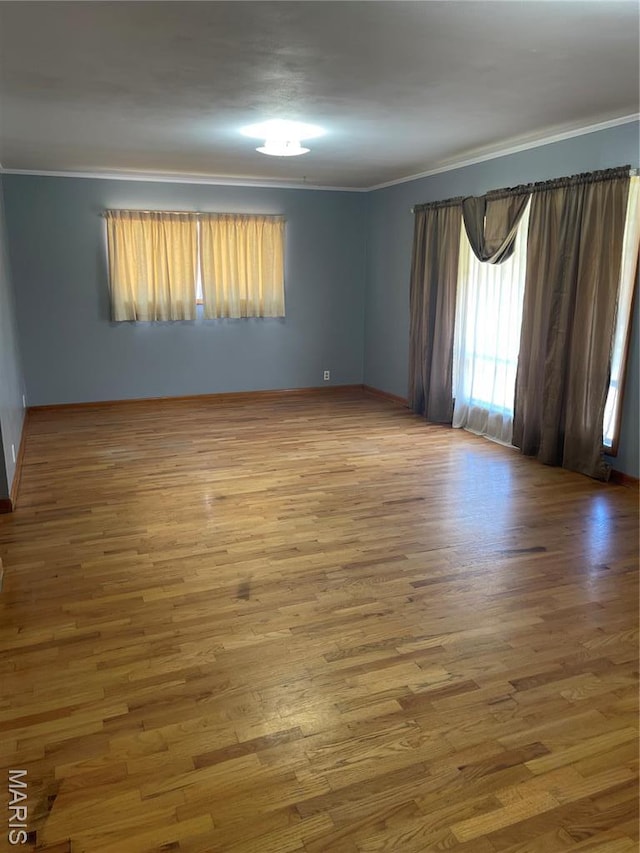 1415 Woodland Rd, Poplar Bluff, MO 63901 - spare room featuring crown molding, wood finished floors, and baseboards