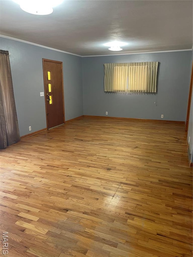 1415 Woodland Rd, Poplar Bluff, MO 63901 - empty room with wood finished floors, crown molding, and baseboards
