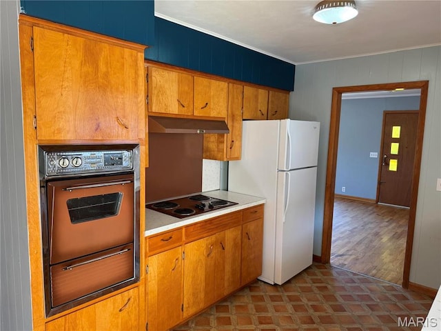 1415 Woodland Rd, Poplar Bluff, MO 63901 - kitchen with oven, electric stovetop, a warming drawer, under cabinet range hood, and freestanding refrigerator