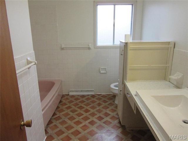 1415 Woodland Rd, Poplar Bluff, MO 63901 - bathroom with tile walls, a baseboard heating unit, tile patterned floors, toilet, and a bath