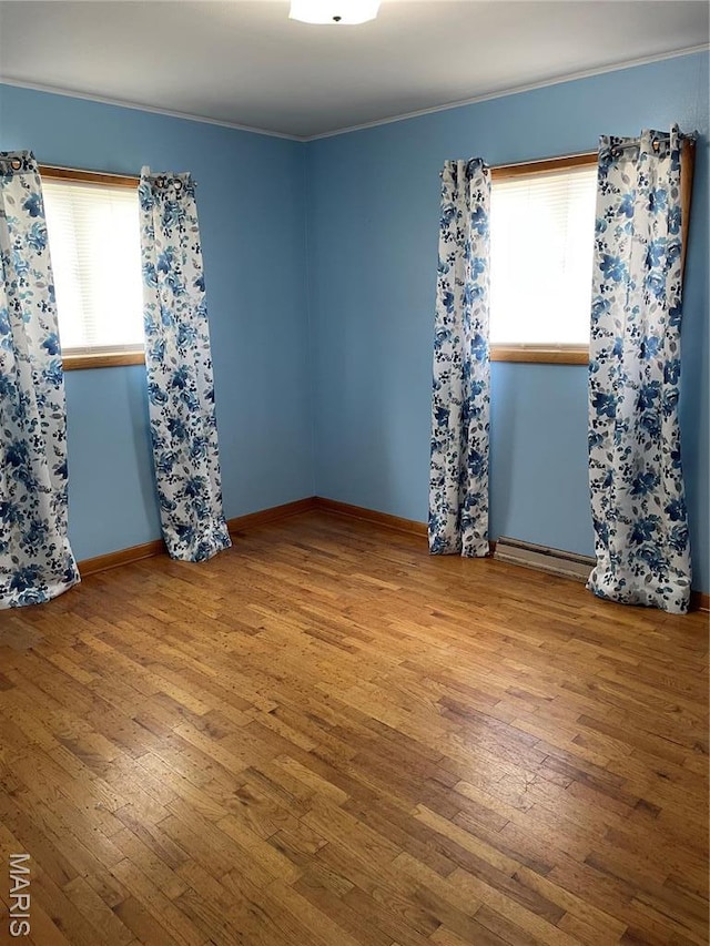 1415 Woodland Rd, Poplar Bluff, MO 63901 - unfurnished room featuring wood-type flooring, crown molding, and baseboards