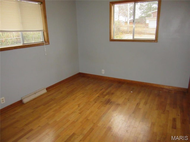 1415 Woodland Rd, Poplar Bluff, MO 63901 - spare room with healthy amount of natural light, light wood finished floors, and baseboards