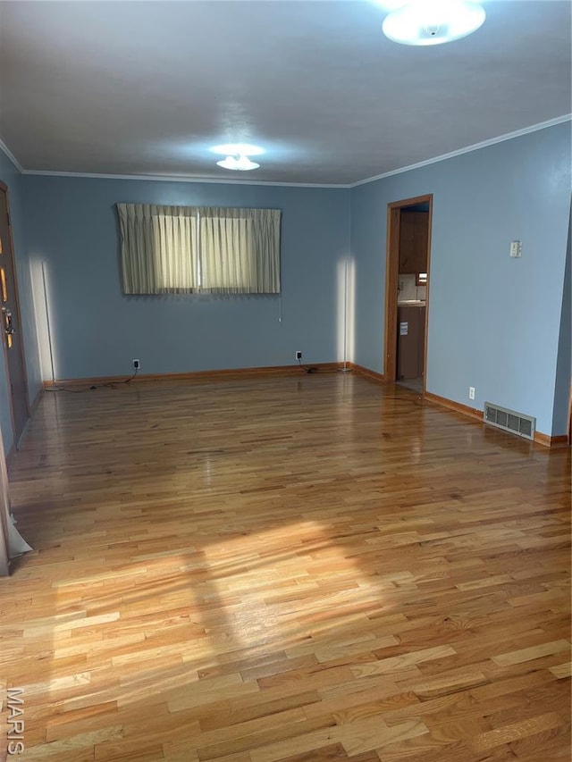 1415 Woodland Rd, Poplar Bluff, MO 63901 - spare room featuring ornamental molding and light wood-type flooring