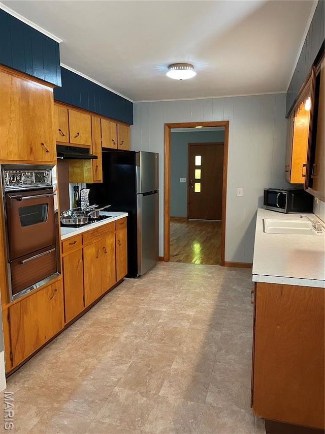 1415 Woodland Rd, Poplar Bluff, MO 63901 - kitchen featuring wall oven, freestanding refrigerator, light countertops, a warming drawer, and brown cabinets