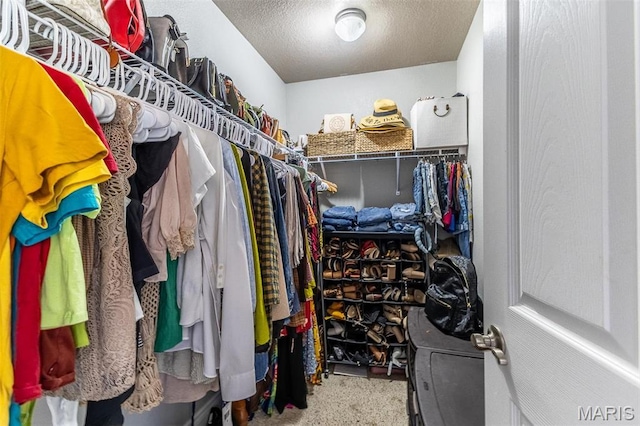 walk in closet featuring carpet
