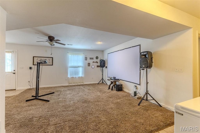 exercise room featuring carpet flooring, a ceiling fan, and baseboards