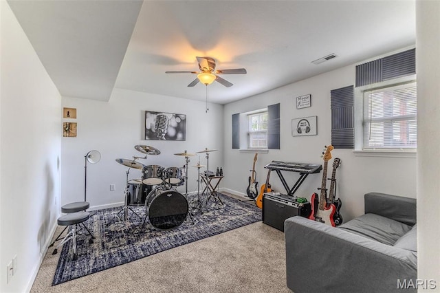 rec room with carpet flooring, a ceiling fan, and baseboards