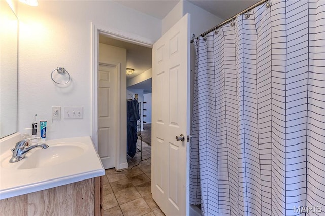 bathroom with tile patterned floors, vanity, and curtained shower