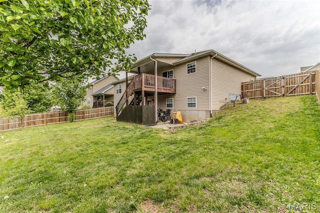 rear view of property featuring a wooden deck