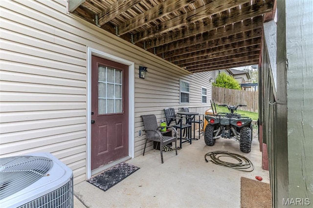 view of patio / terrace with central AC unit and fence