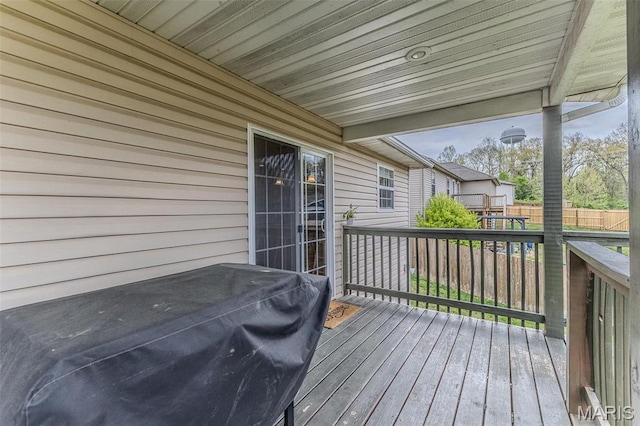 wooden deck with grilling area and fence