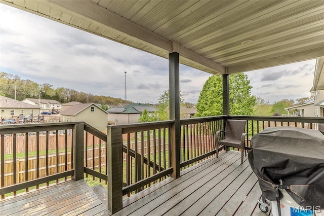 wooden terrace featuring a residential view and area for grilling