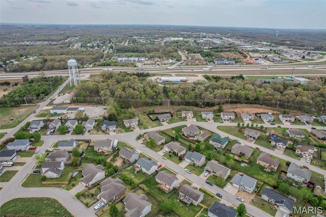 aerial view of property and surrounding area with nearby suburban area