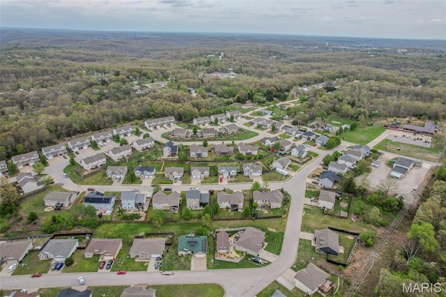 aerial overview of property's location with a heavily wooded area and nearby suburban area