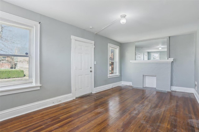 4644 Minnesota Ave, Saint Louis, MO 63111 - empty room featuring plenty of natural light, a fireplace, and wood finished floors